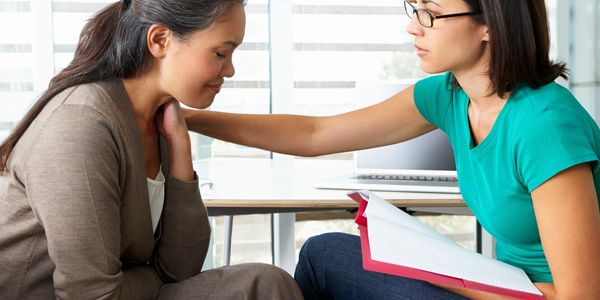 Counselor comforting a client during a therapy session